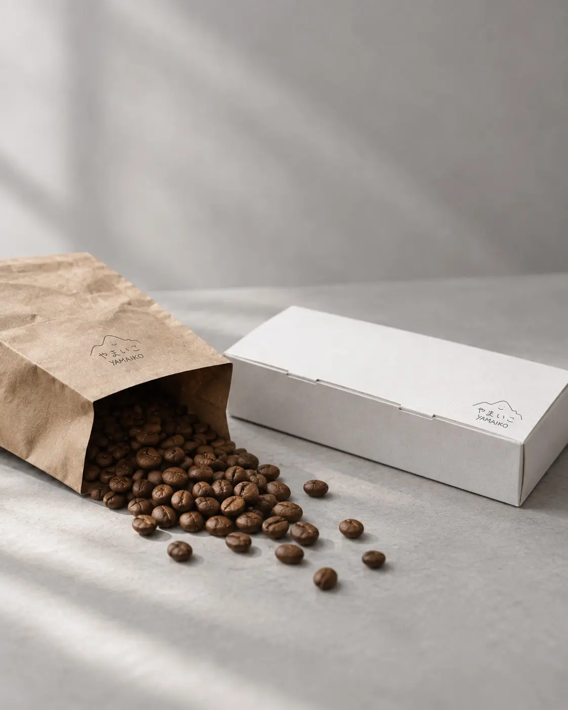 YAMAIKO packaging with coffee beans in soft window light